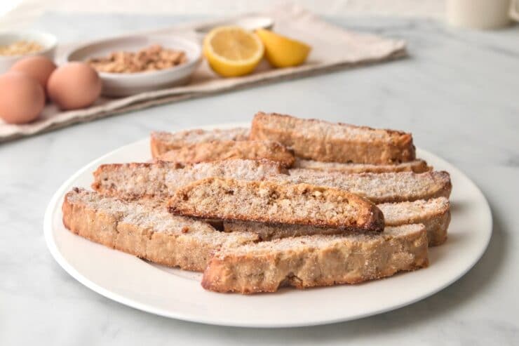 Horizontal shot of a white plate containing a pile of mandel bread.