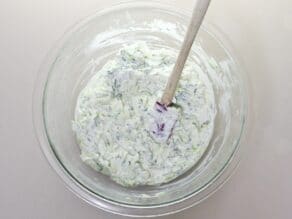 Horizontal shot - glass bowl filled with cucumber raita.