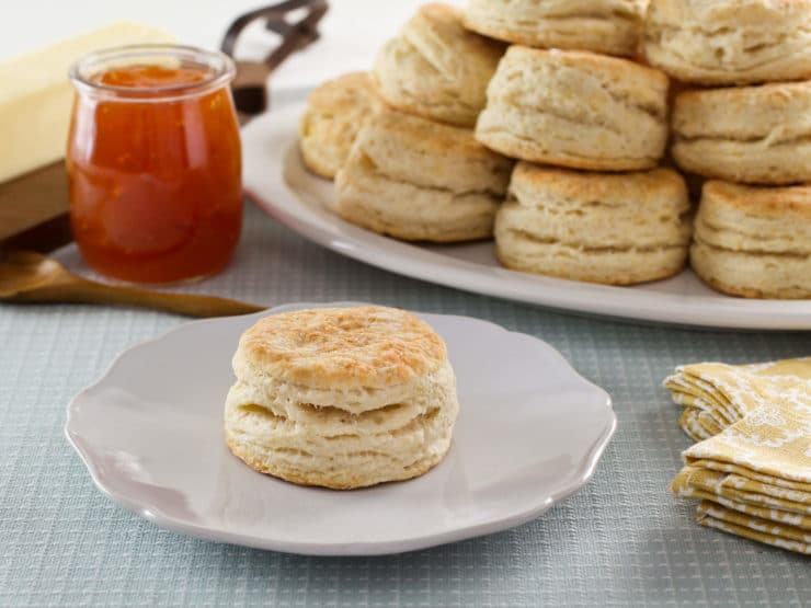 Flaky Buttermilk Biscuits close-up in white plates with a jam on the side