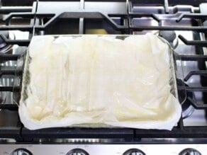 Overhead shot of a sheet of phyllo dough on a metal baking tray.