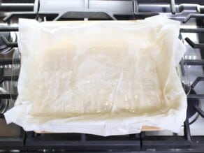 Horizontal overhead shot of a sheet of phyllo dough laying in a rectangular baking dish.