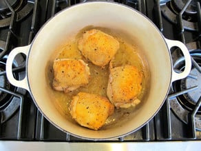 Browning chicken thighs in a Dutch oven.