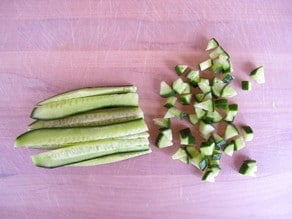 Dicing cucumber strips.