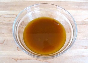 Olive oil dressing in a small bowl.