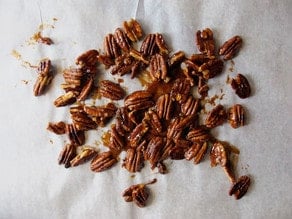 Candied pecans on wax paper to dry.