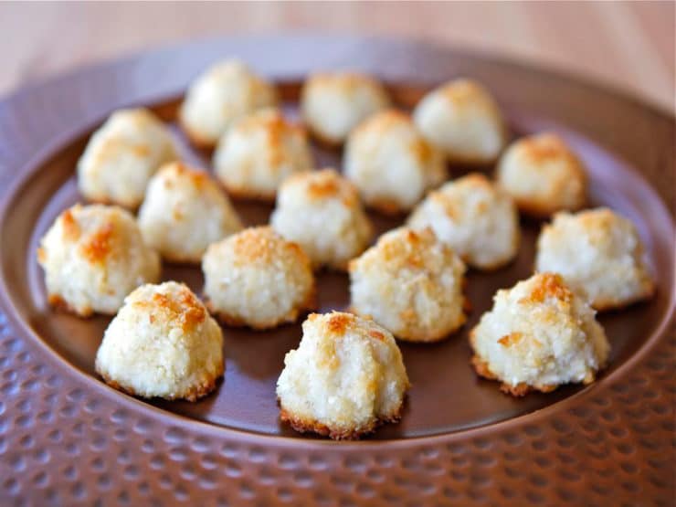 A plateful of Lemony Almond Macaroons on top of a wooden table