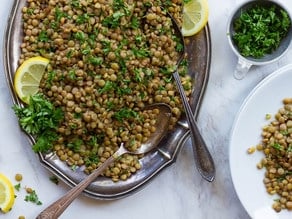 Lemon Lentil Parsley Salad on a long silver-like plate with spoons