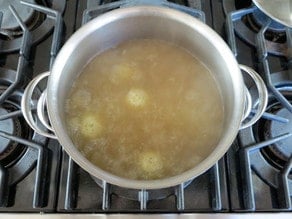 Cooking sinker matzo balls in stock.