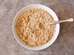 Roasted eggplant mashed with a fork.