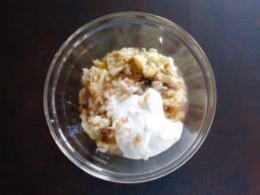 Roasted eggplant, roasted garlic, tahini and Greek yogurt in glass bowl.