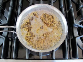 Lentils cooking in a saucepan.