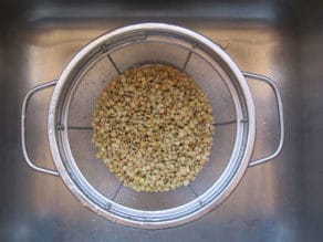 Rinsing lentils in a colander.