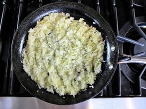 Sauteing onions in a skillet.