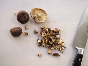 Chopping soaked mushrooms.