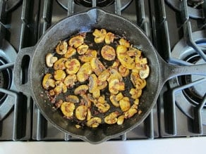 Sliced mushrooms in a skillet.