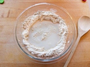 Wet ingredients added to dry in mixing bowl.