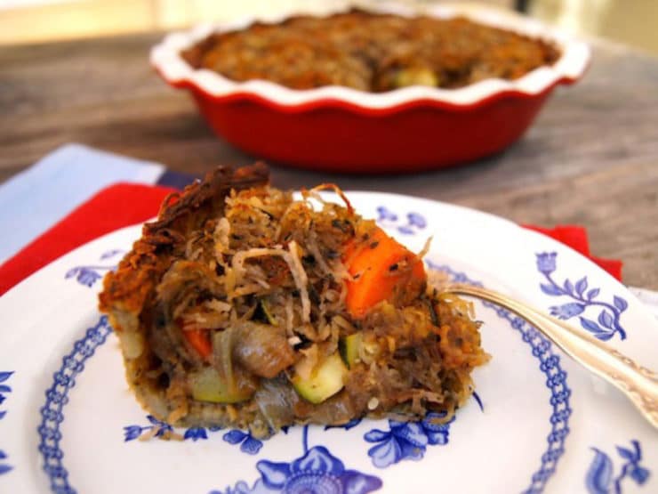 A savory potato pie with roasted vegetables, topped with a crispy potato crust