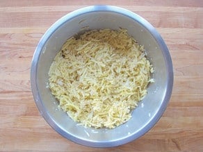 Egg and seasoning mixed into shredded potatoes.