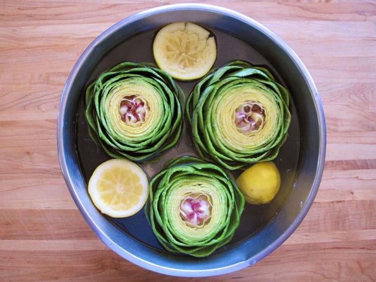 Cleaning, Steaming, and Eating Artichokes - Learn how to clean and trim whole artichokes for steaming, how to reach the steamed artichoke heart, and how to eat steamed artichokes.