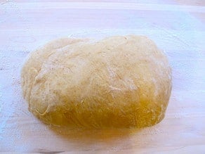 Smooth challah dough roll.