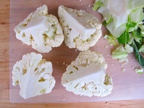 Cutting head of cauliflower into quarters.