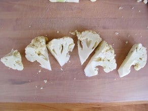 Cutting cauliflower into florets.