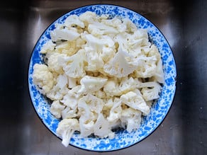 Cauliflower florets in a colander.