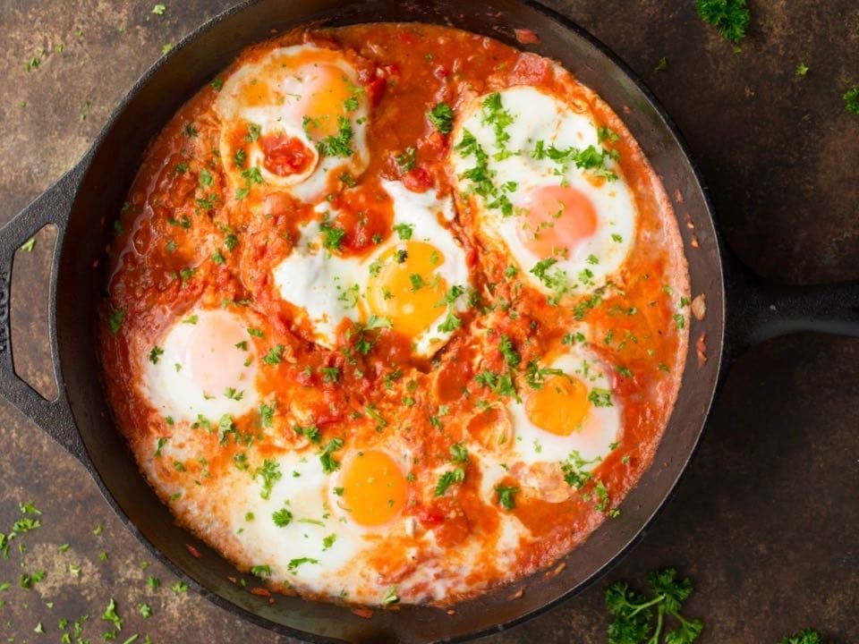 Horizontal shot of cast iron pan filled with Shakshuka