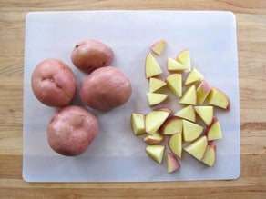 Potatoes sliced into wedges.