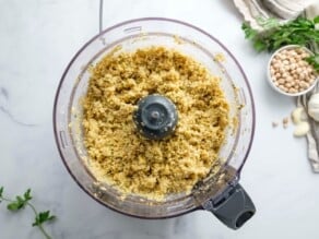 Overhead image of a food processor bowl filled with falafel batter.