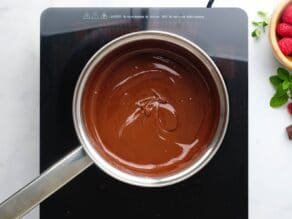 Horizontal overhead shot of a saucepan filled with melted chocolate.