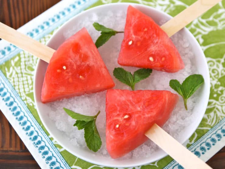 Watermelon Mojito Pops on a plate garnished with fresh mint leaves