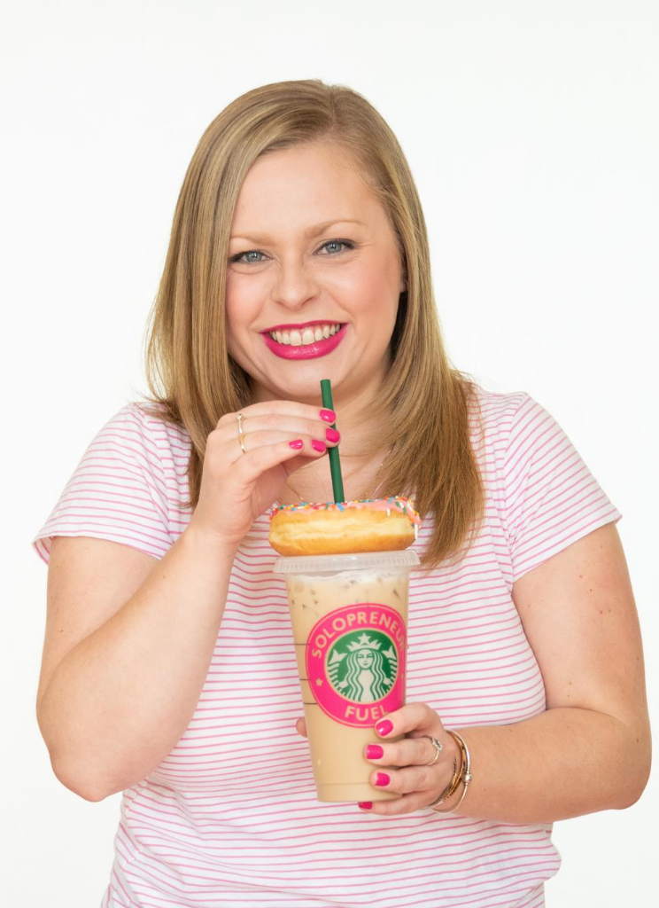 Alexandra of The Productivity Zone holding an iced coffee with a sprinkle doughnut on top