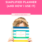 Blonde woman holding a Happy Stripe Daily Simplified Planner in front of her face